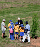 Students from Giralang Primary School (A member of the Friends of the National Arboretum Canberra.) surround Olympic, World and Australian champion Basketball player Lauren Jackson. Click for larger image.