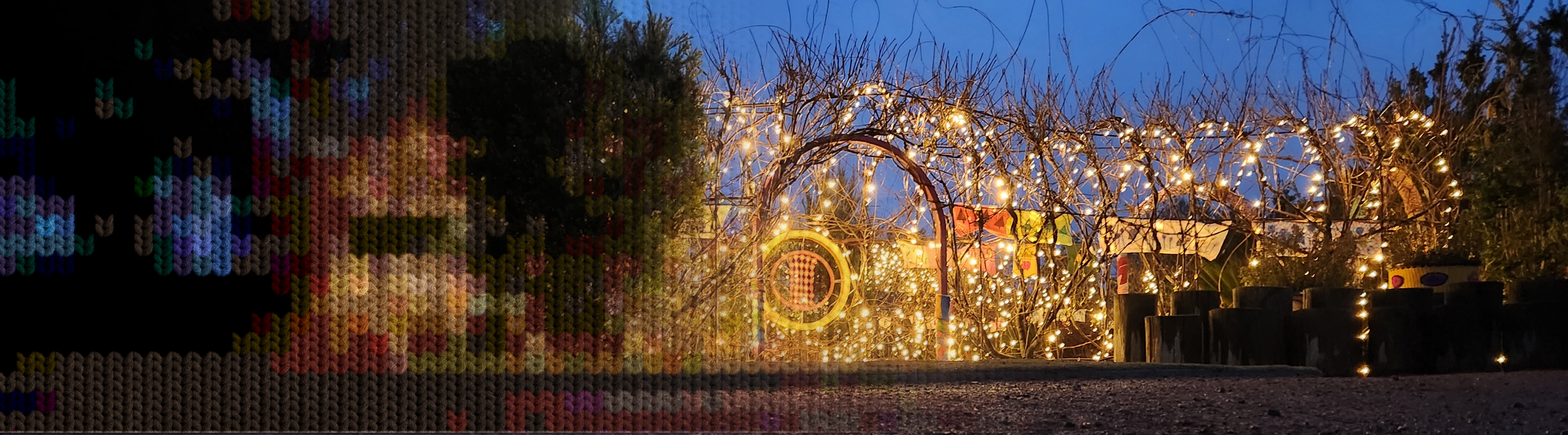 A large garden arbor is decorated with fairy lights and glowing at night