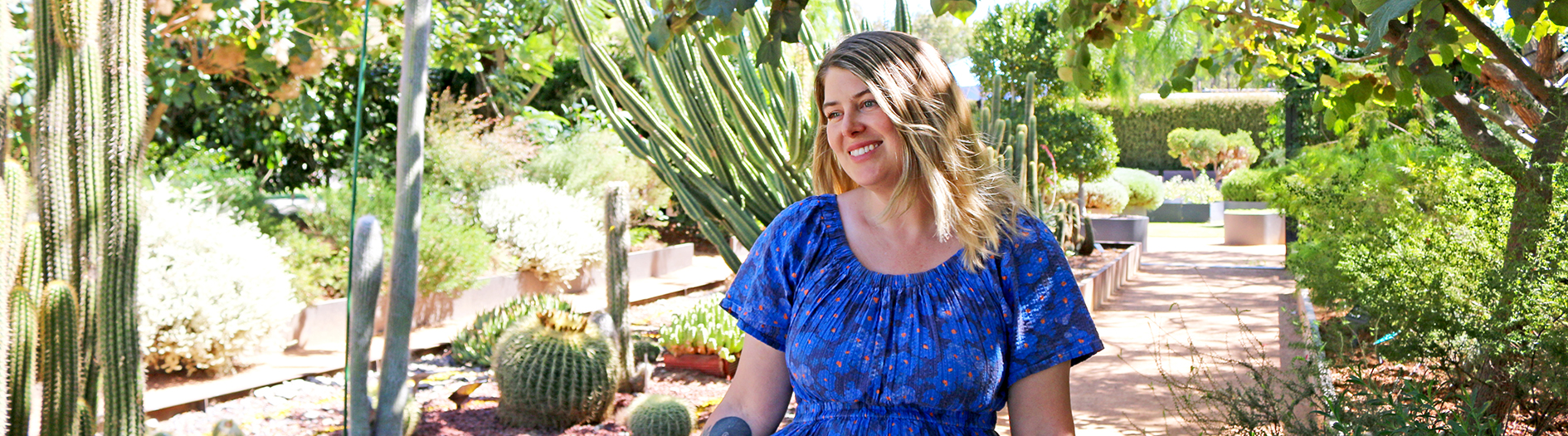 Amalie Shawcross photogrpahed in the Discovery Garden,  smiling, looking to the side