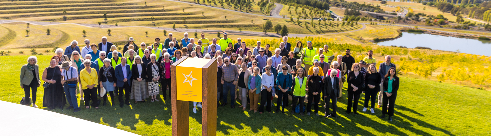 Group photo of all the people involved with the Arboretum from staff to Friends, Volunteers, donors and sponsors to community groups. The gold trophy is placed in the foreground.