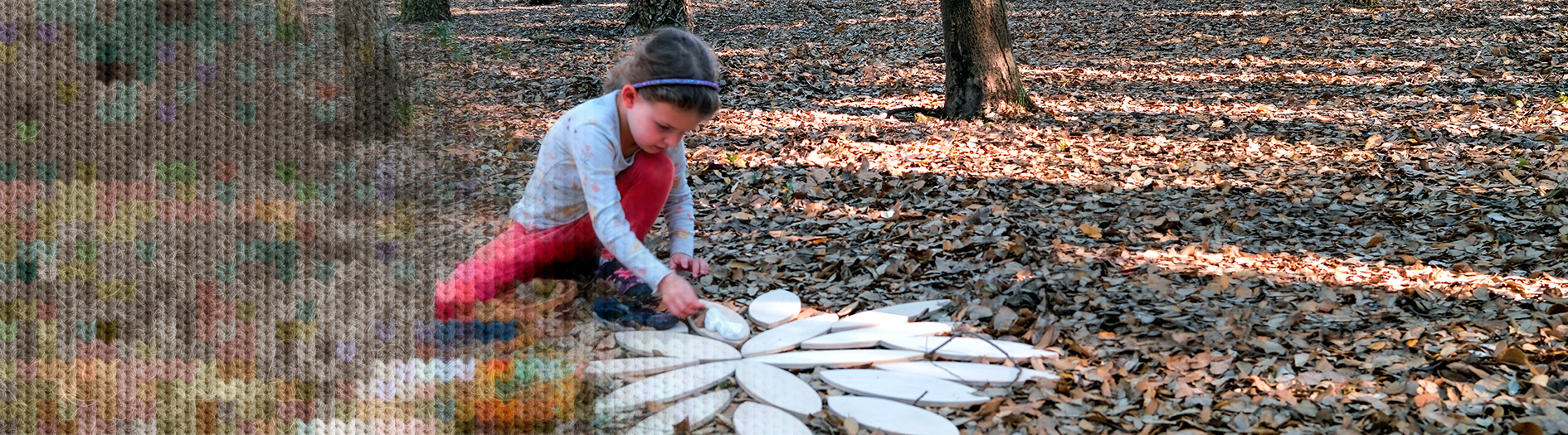 A child plays with wooden mandala shapes on a leafy forest floor. The image has a knit pattern overlay over one end of the image to create a cosy winter effect