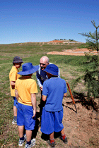 Students from Giralang Primary School, speak with Former World Marathon Champion Robert de Castella at the tree planting ceremony. Click for larger image.