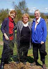 Jocelyn Sherry and Trish standing around the newly planted tree